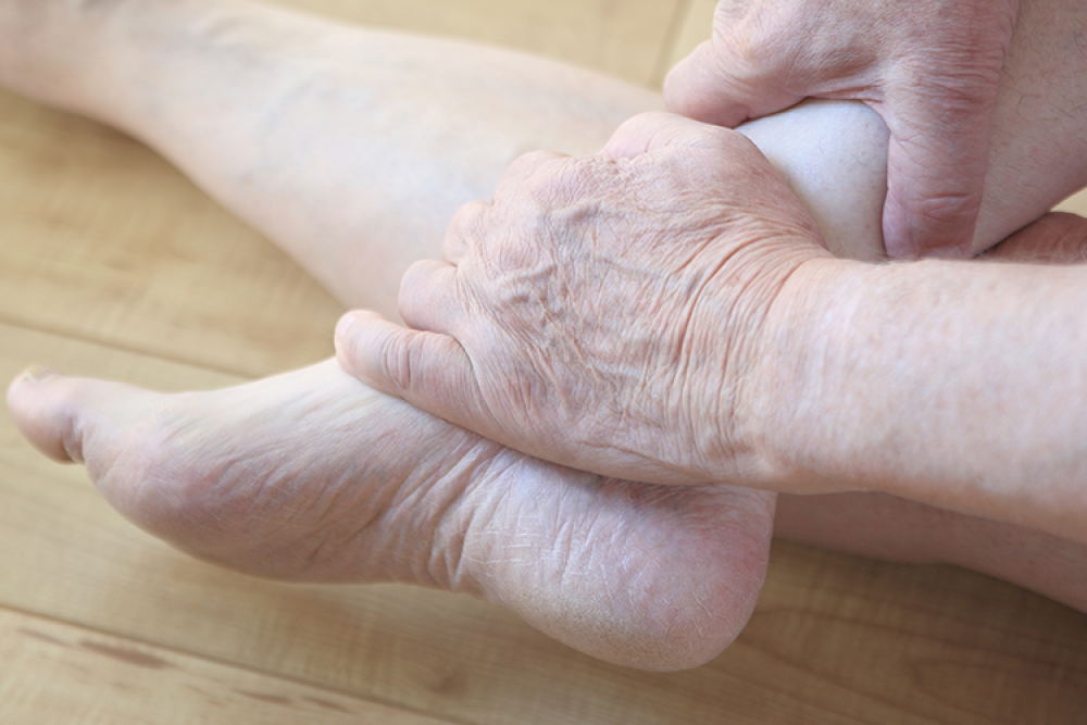 woman holding her foot with arthritis