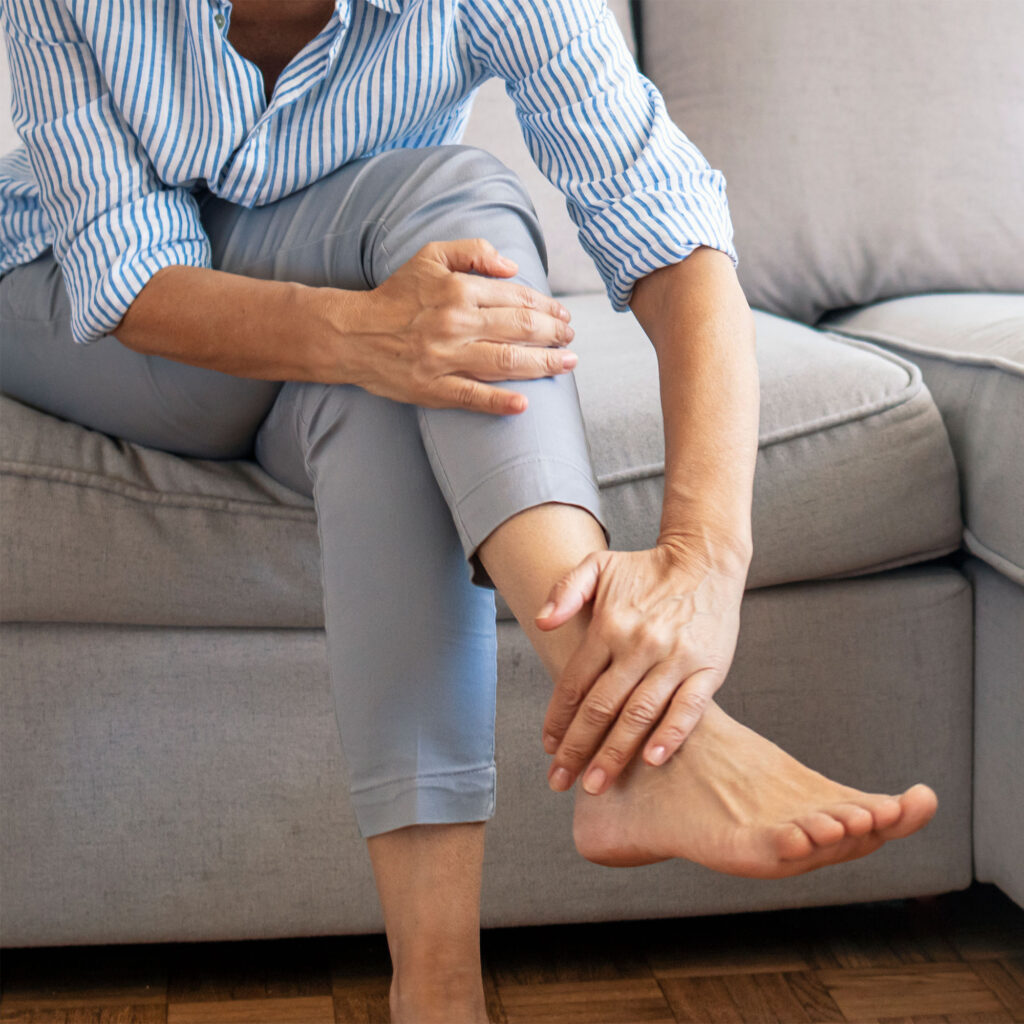 woman touches his foot with Arthritis