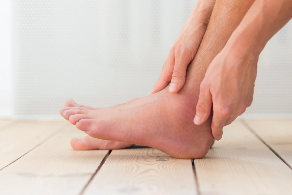 a girl holding her foot tendon