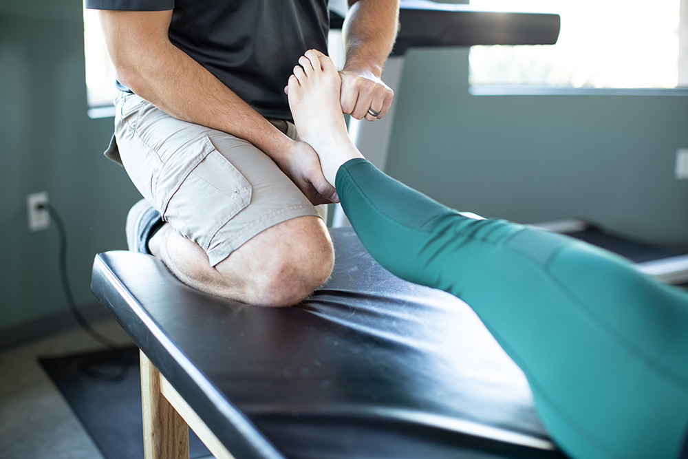 trainor stretching a woman's foot