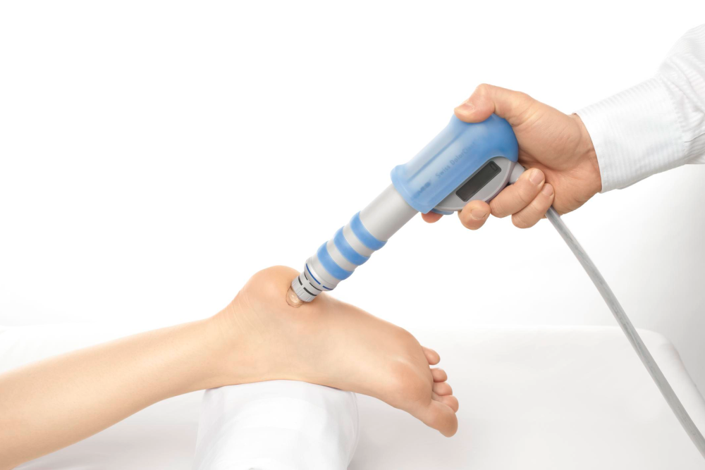 doctor holding a blue laser for foot