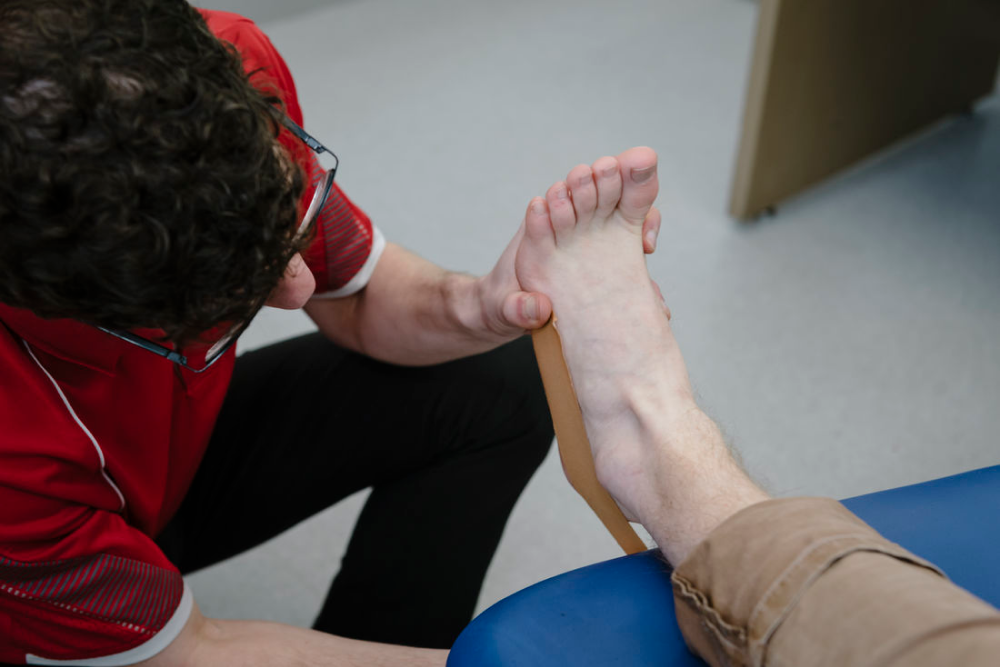 health care putting pad to a patient foot